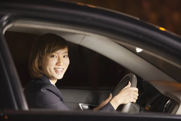 Chinese businesswoman driving car