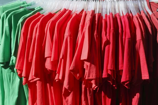 red t-shirts on hangers