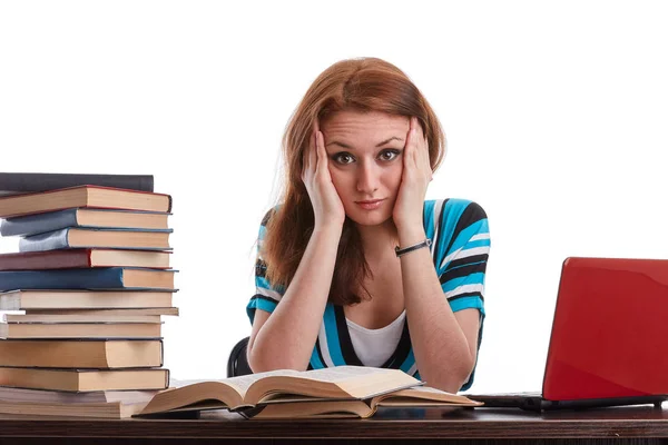 Jovem Estressada Sentada Uma Mesa Entre Livros Laptop Fundo Branco — Fotografia de Stock