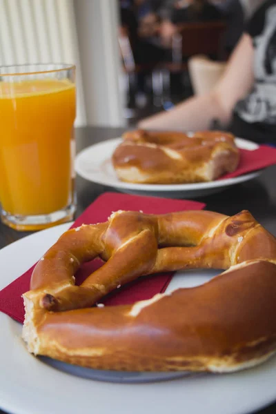 Pretzel Bread White Plate Orange Juice Wooden Table — Stock Photo, Image