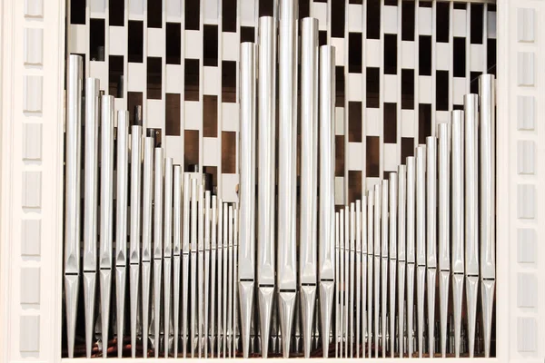 organ pipes with chess pattern in the background