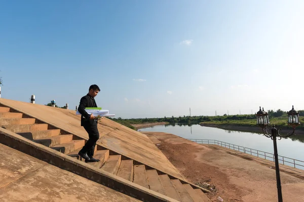 Asian Young Man Engineers Holding Blueprint While Walking Stairs Floodgates — Stock Photo, Image