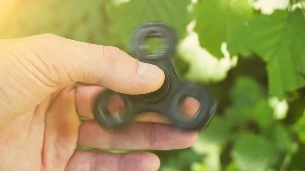 Playing Black Fidget Spinner Toy Spinner Hand Sun Effect — Stock Photo, Image