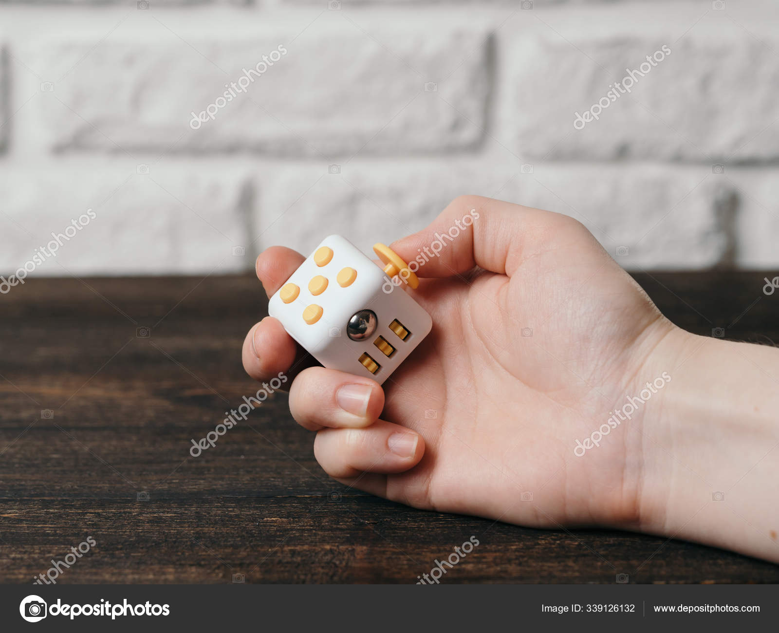 Fidget Cube Stress Reliever Hand Brown Wooden Background Fingers Antistress  Stock Photo by ©PantherMediaSeller 339126132