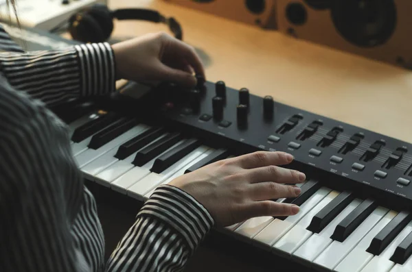 Woman Striped Shirt Plays Synthesizer Tunes Body Frame Nearby Headphones — Stock Photo, Image