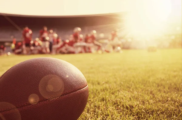 Close up of an american football on the field in the sunshine
