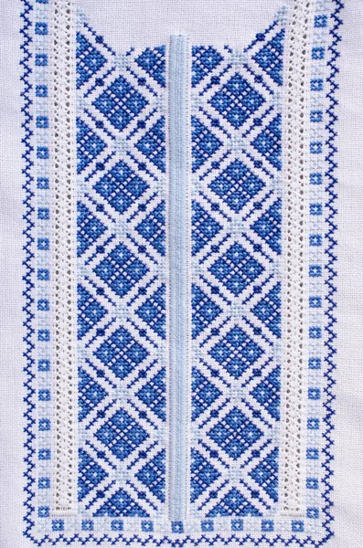 Ukrainian folk patterns embroidered with a cross on a white canvas. Slavic embroidery for background.