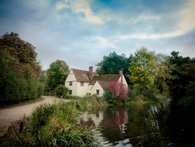 willy's lott's famous old white cottage house in flatford suffolk clipart