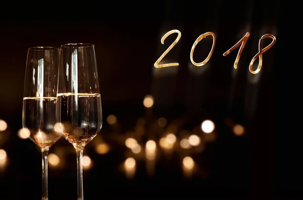 new year background with sparkling wine and golden year number 2018