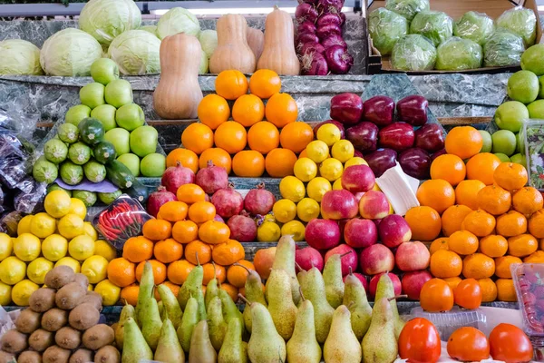 fruit mix, combination of different fruits, decoration on market stall, fruits in different colors, apples, plums, avocados, kakis, pears, kiwis mangos melons pineapples oranges