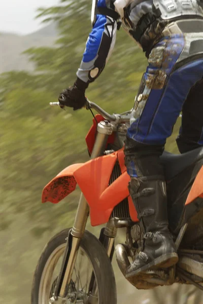 Low angle view of a motocross rider riding a motorcycle