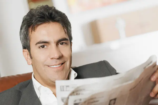 Portrait of a mature man reading a newspaper