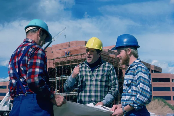 Construction crew looking at blueprints