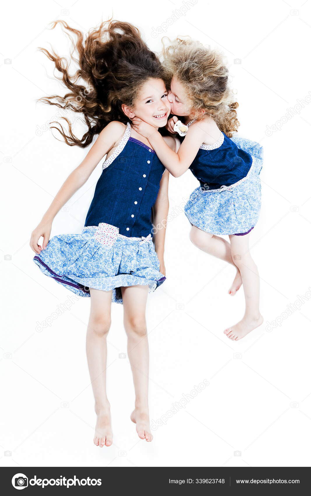 two little girls kissing 
