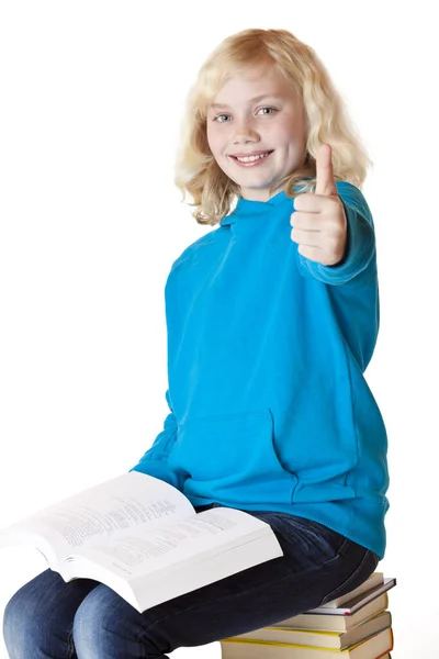 Happy Schoolgirl Shows Thumb Sitting Pile Books Isolated White Background – stockfoto