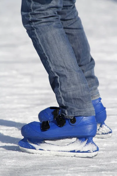 man in skates with snowboard on the ice rink