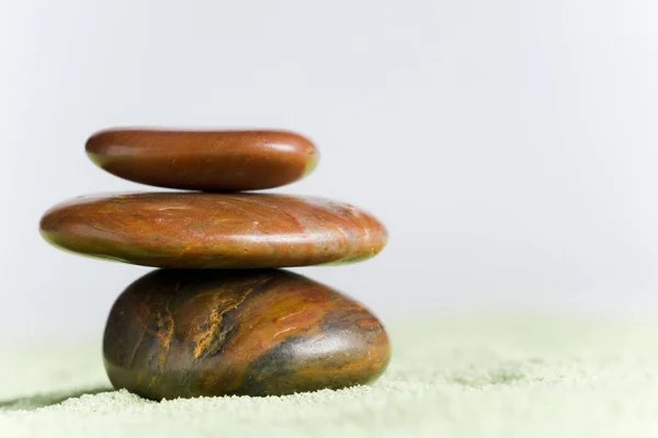 Brown Stones Balance Green Sand Front White Background — 스톡 사진