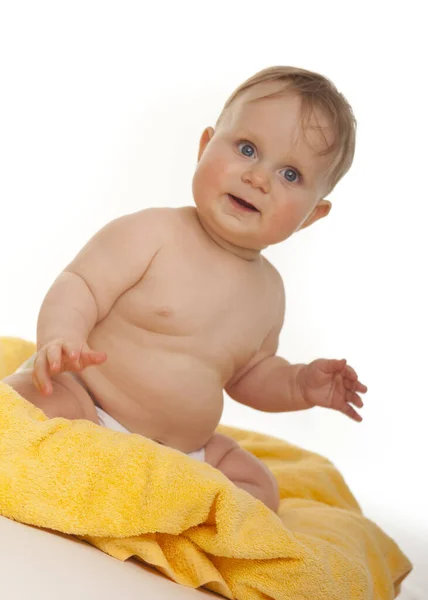 Portrait Happy Baby Sitting Yellow Towel White Studio — Stock Photo, Image