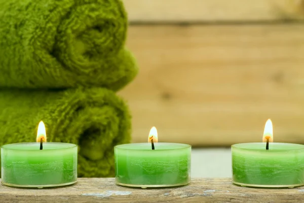 Three Wellness Candles Green Towels — Stock Photo, Image