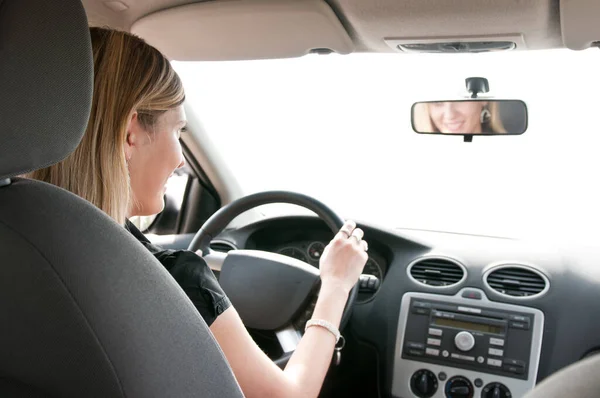 Young Cheerful Woman Driving Car Rear View Reflexion Mouth Mirror — 图库照片