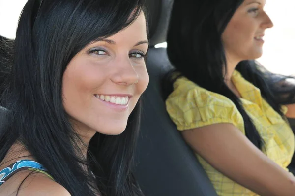 車で運転する2人の笑顔の友人 10代の女の子 フロント女性に焦点を当てる — ストック写真