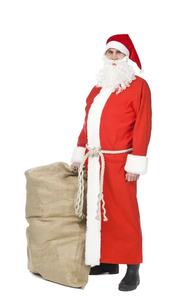 圣诞老人带着袋装的礼物与白色背景隔离在一起 — 图库照片
