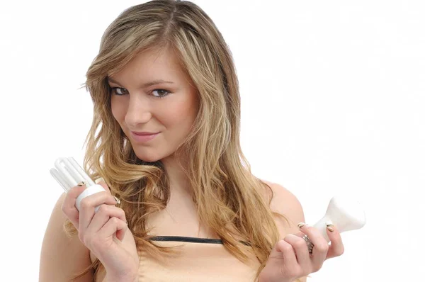 Young Woman Compares Classic Lightbulb New Efficient Energy Saving One — ストック写真