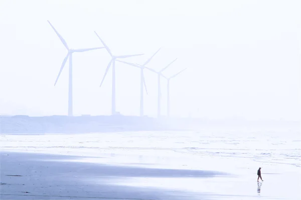 夕方にはビーチの近くに光霧と風力発電 — ストック写真