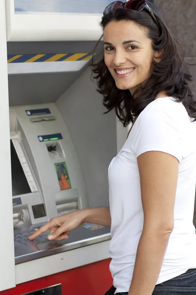 woman gives a pin at the atm