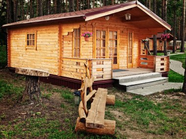 House and bench at the forest in the evening clipart