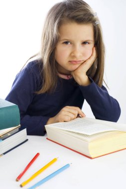 six year old girl sitting listlessly in front of a book (mr) clipart