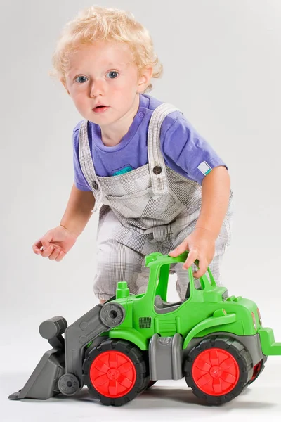 Blond Handsome Boy Playing Green Tractor — Stock Photo, Image
