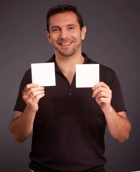 Young Man Holding Blank Card Isolated Black — Stock Photo, Image