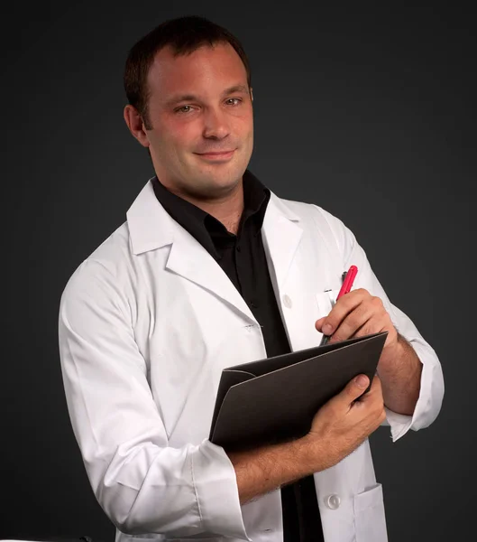 Joven Con Uniforme Médico Tomando Notas —  Fotos de Stock