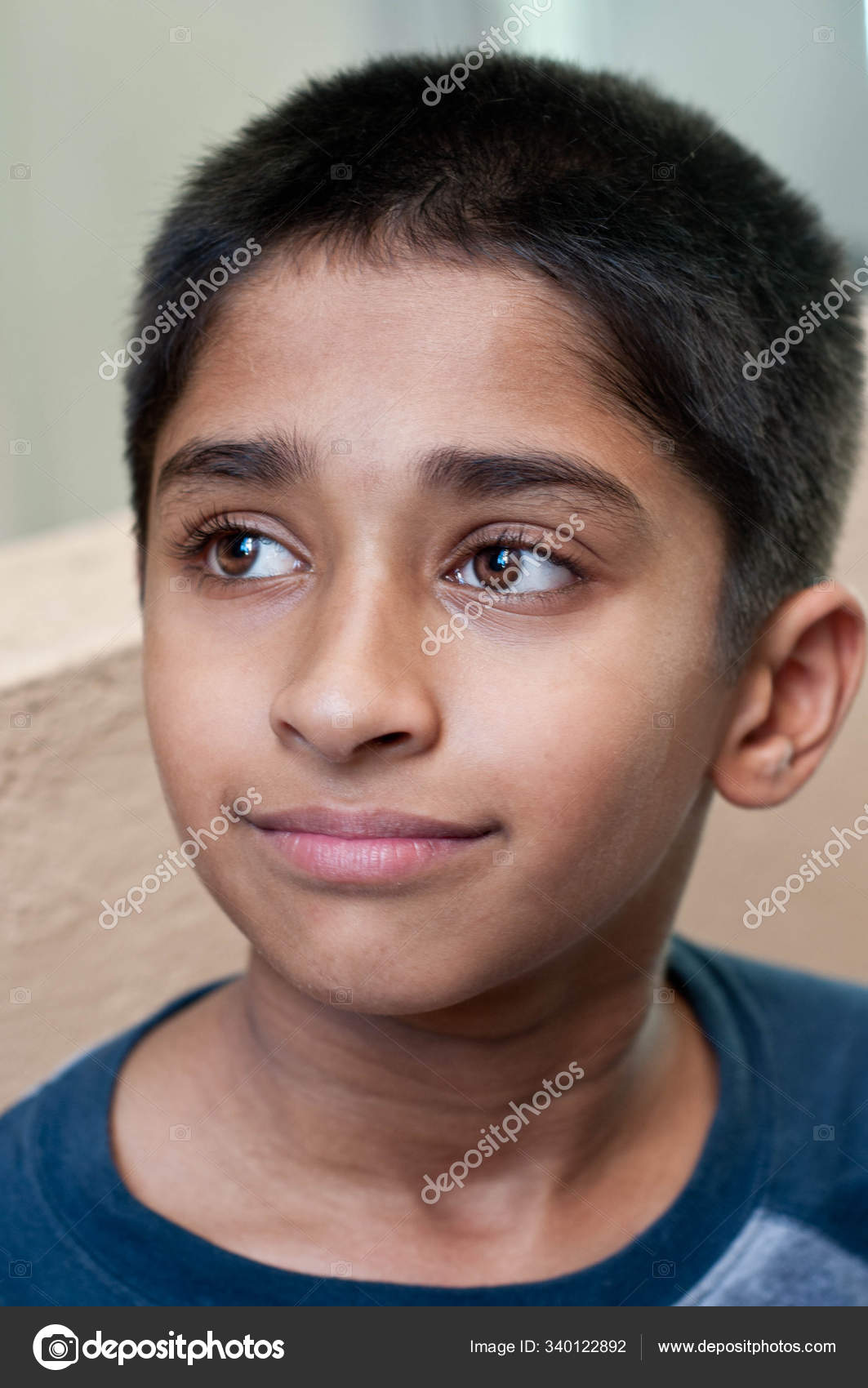 Adorable Young Indian Boy Day Dreaming Stock Photo by