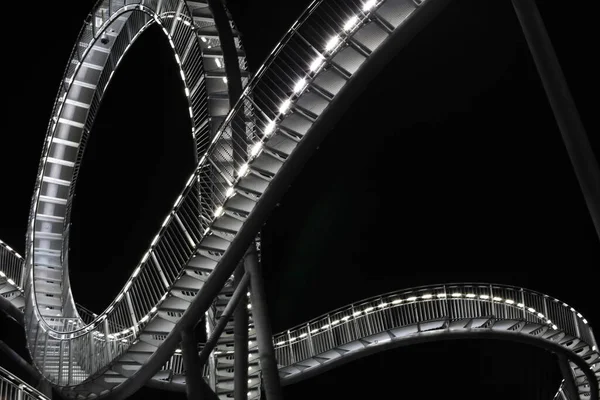 roller coaster sculpture at night