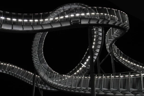 roller coaster sculpture at night