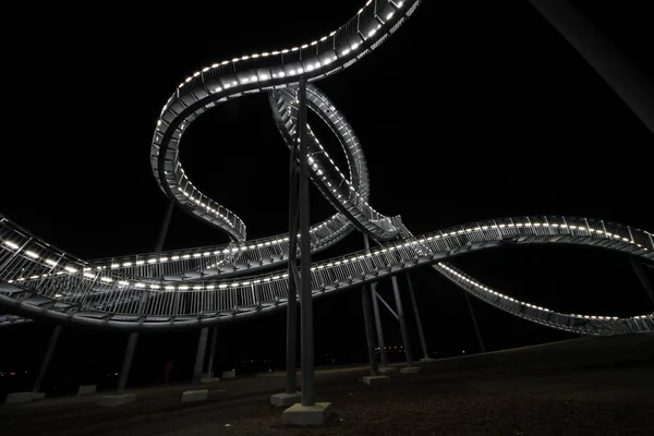 Roller coaster sculpture at night