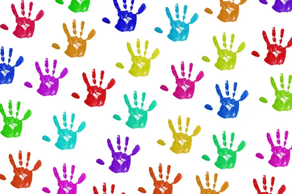 close up colorful child handprints on white