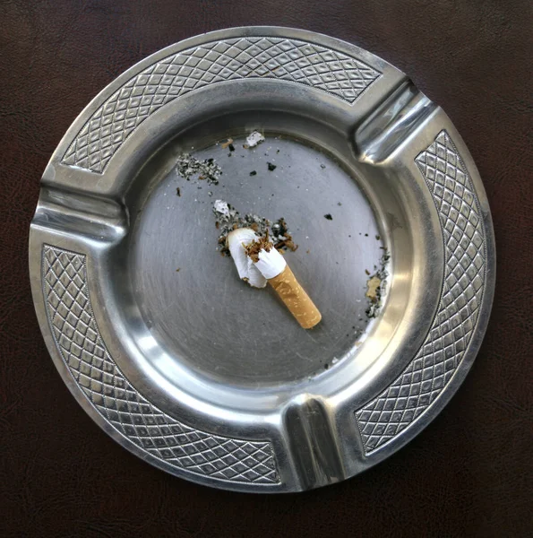 Cigarette stick on silver round ashtray photo – Free Tobacco Image