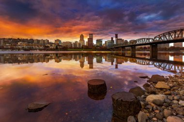 A beautiful sunset over downtown Portland Oregon waterfront along Willamette River from Eastbank Esplanade clipart