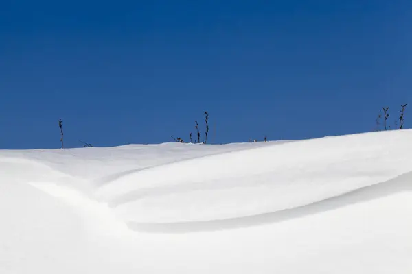Piękna Krzywa Nierówny Śnieg Tle Błękitnego Nieba Zimie Zbliżenie — Zdjęcie stockowe