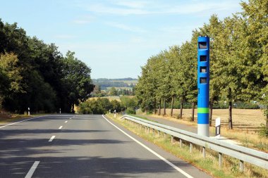 LEISENAU, GERMANY - JULY 29, 2018: One of around 600 blue enforcement pillars of the German Toll Collect company at the federal highway B 107 in Saxony. Since July 1st 2018 the truck toll applies to all federal trunk roads. clipart