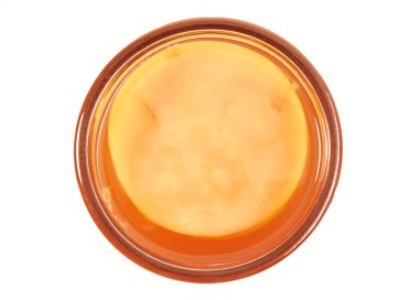 Glass container of freshly fermented kombucha made with black tea isolated on white viewed top down clipart
