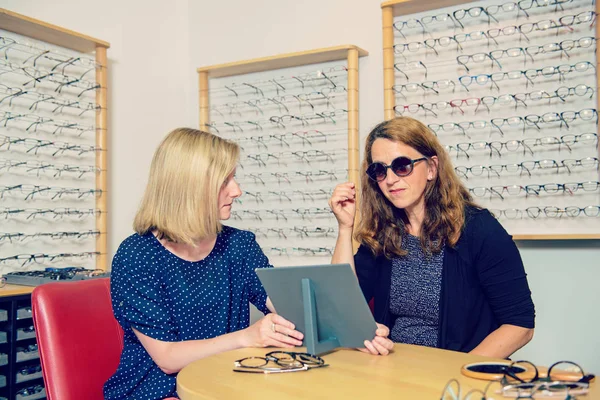 Optician Shop Woman Selecting New Sunglasses Looking Mirror — Stock Photo, Image