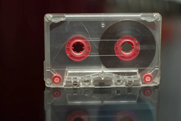 Old audio cassette on a black background, audio recording