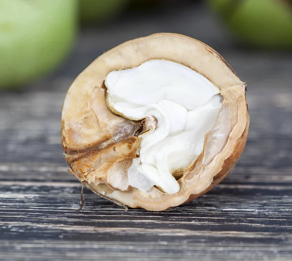 half broken walnut shells with edible part, close-up