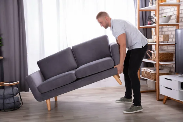 Side View Young Man Lifting Sofa Home — Stock Photo, Image