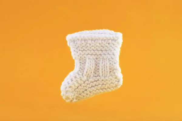 White Baby Sock Orange Background — Stock Photo, Image