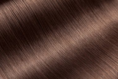 Closeup on luxurious straight glossy brown hair clipart